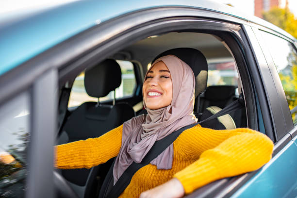 beautiful woman with hijab driving a car. - car test drive car rental women imagens e fotografias de stock