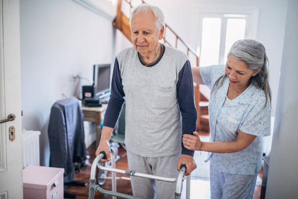 istock Senior woman supporting her husband using mobility walker at home 1194679336