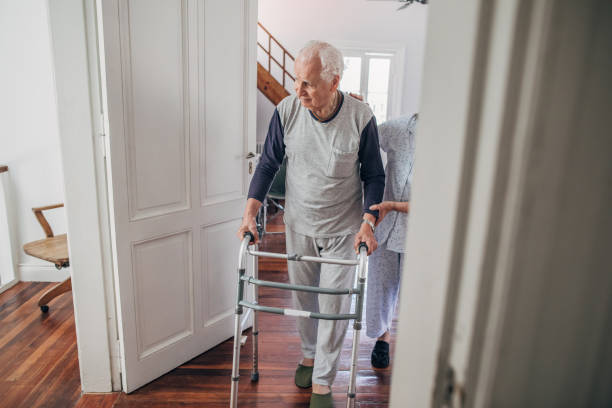 istock Senior woman supporting her husband using mobility walker at home 1194679408