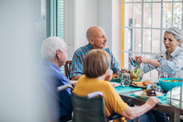 istock Seniors having meal in their retirement home 1194679587