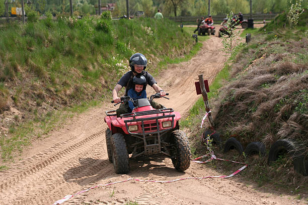 Dad with son riding a quad bike 