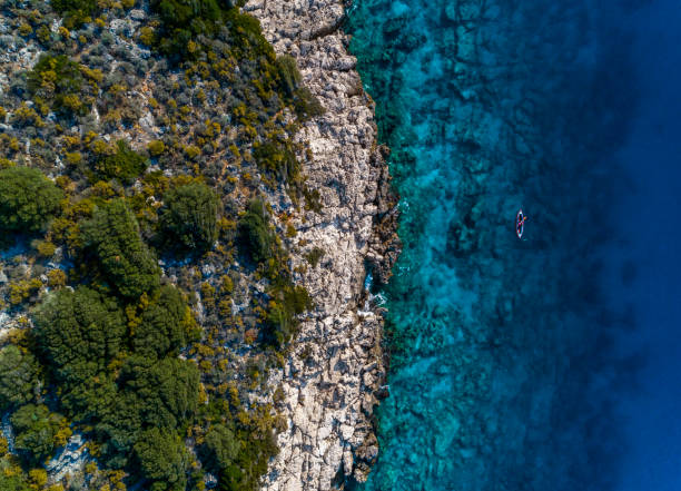 istock Woman kayaking clear turquoise sea 1194680842