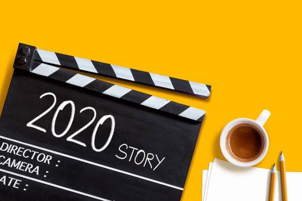 istock 2020 story- text title on film slate.and coffee cup. 1194681789