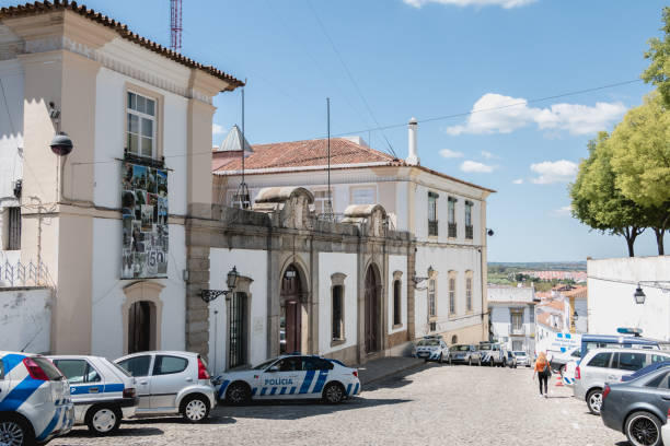 small police station neighborhood next to the cathedral basilica Our Lady of the Assumption of Evora Evora, Portugal - May 5, 2018: view of the small police station neighborhood next to the cathedral basilica Our Lady of the Assumption of Evora a spring day psp stock pictures, royalty-free photos & images