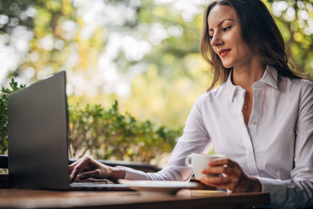 istock Business lady using laptop in sidewalk cafe 1194685146