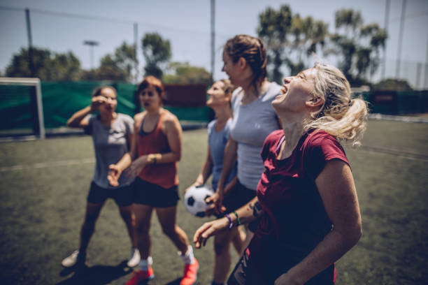 istock Women standing on a soccer playing field 1194685154