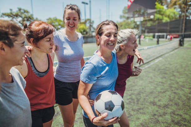 istock Women standing on a soccer playing field 1194685211