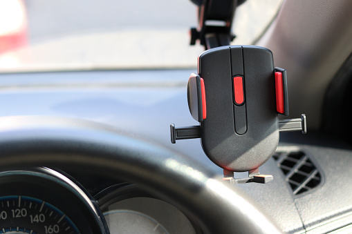 Mobile phone holder on the car for safety while driving a vehicle.
