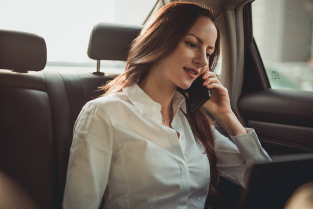 istock Business lady talking on mobile phone in car 1194685918