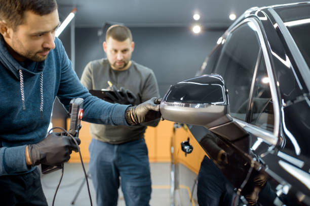istock Workers examining vehicle body for scratches 1194687606