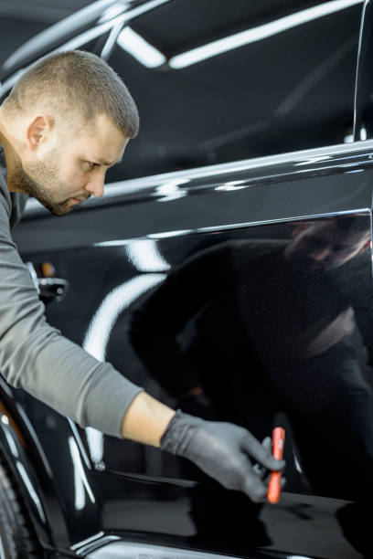 istock Worker examining vehicle body for scratches 1194687907
