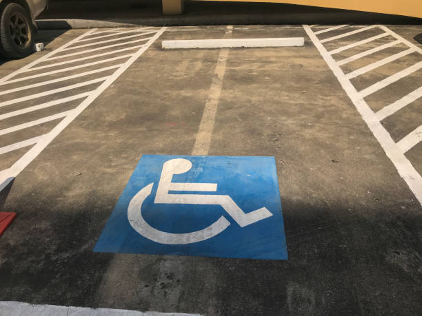 istock car parking for disable people sign on concrete road 1194688932