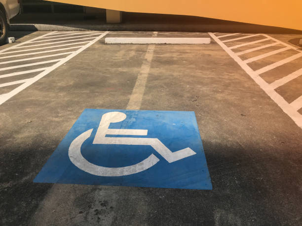 istock car parking for disable people sign on concrete road 1194689006