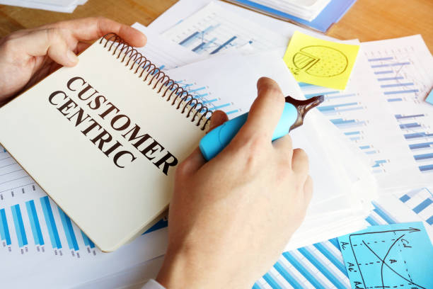 istock Man holds papers with Customer centric business conception. 1194689020
