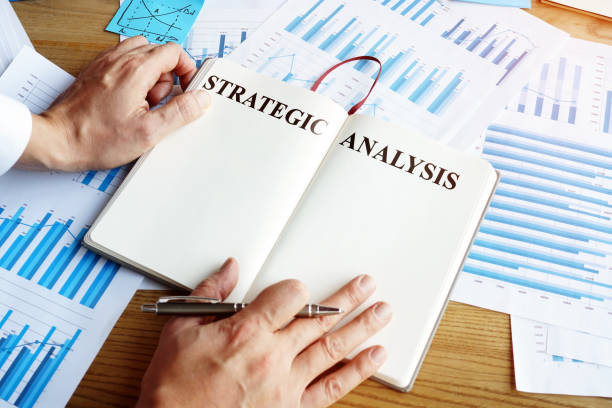 istock Man reads Strategic analysis in the room. 1194689319