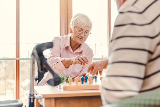 Two seniors in a nursing home playing a board game