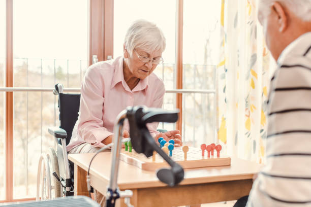istock Two seniors in a nursing home playing a board game 1194696906