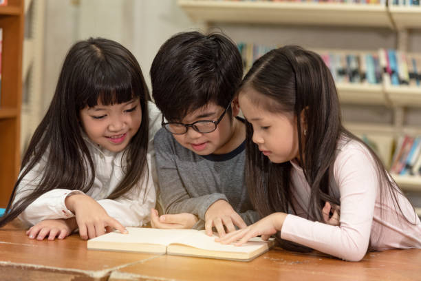 istock Education image,asian children happy learning in library at school. 1194697918