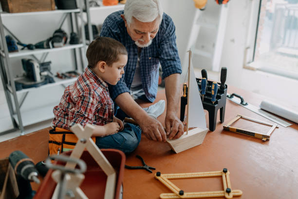 istock Grandfather and grandson building a ship 1194697942