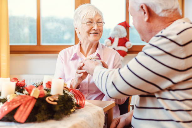 istock Seniors in nursing home exchanging presents for Christmas 1194697968