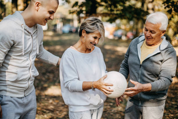 istock Multigenerational group of people plays volleyball 1194698518