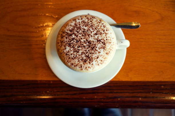 Cappuccino coffee cup on wooden table background