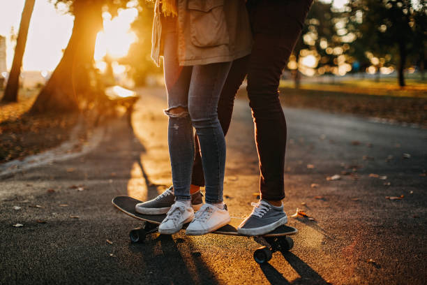 istock Young woman and young man ride skateboard 1194699174
