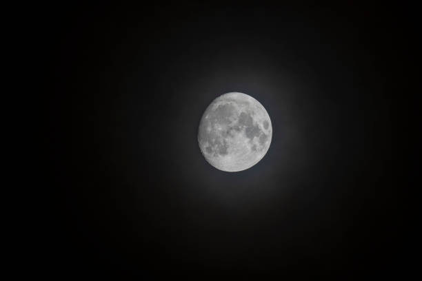 istock Moon over black sky with some fog 1194699667