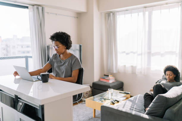 Young and beautiful black woman using laptop at home