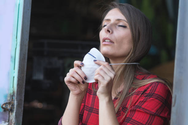 istock young woman putting face mask for polluted air 1194702352