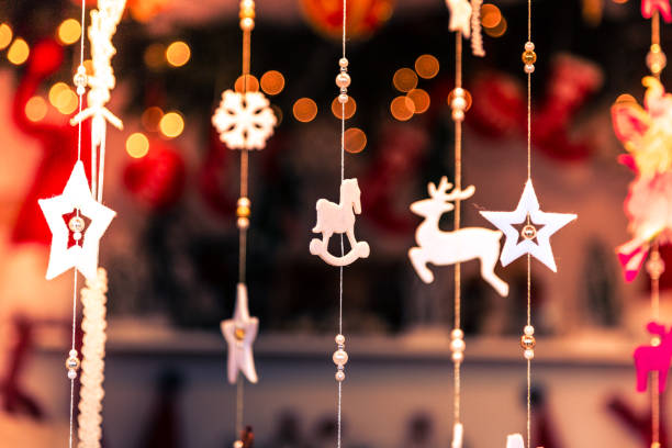 istock Handmade traditional ceramic Christmas decorations hanging on display at Christmas market 1194703113