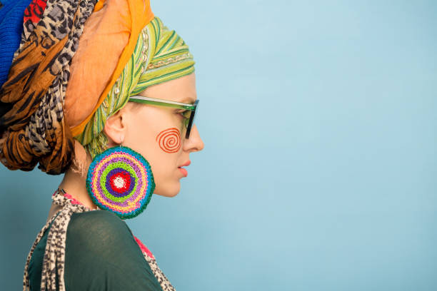 woman with a turban on her head, fashion earrings and a bracelet. Africa style woman concept