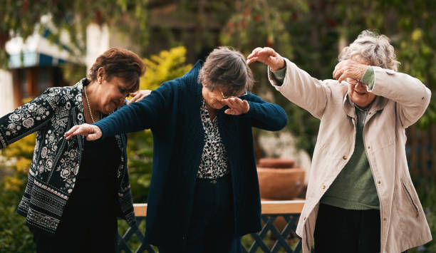 Keeping up with trends Cropped shot of a group of senior woman standing together and dabbing during a tea party outdoors dab dance photos stock pictures, royalty-free photos & images