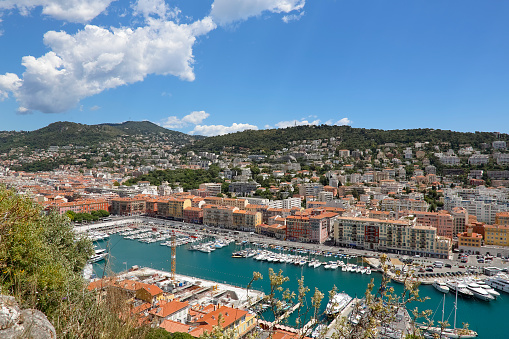 Nice, France - May 15, 2014: Port Lympia also called Old Harbor built on the outskirts of the city in 1750, with an area of 127,500 sqm at water level, acts as commercial port, marina and fishing port. The city of Nice is located on the French Riviera in the Provence-Alpes-Cote d'Azur region. The city and its old town are full of historic buildings, churches, and due to its narrow and shady streets let you feel the spirit of Old Nice. Contemporary architecture also underlines the modern character of the city. Nice is one of the most populated urban areas in France and is located on the southeastern coast of France, on the French Riviera, on the Mediterranean Sea.