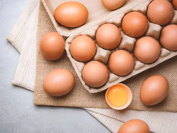 Top view and close up image of organic chicken eggs are one of the food ingredients on the restaurant table in the kitchen to prepare for cooking. Organic chicken eggs food ingredients concept