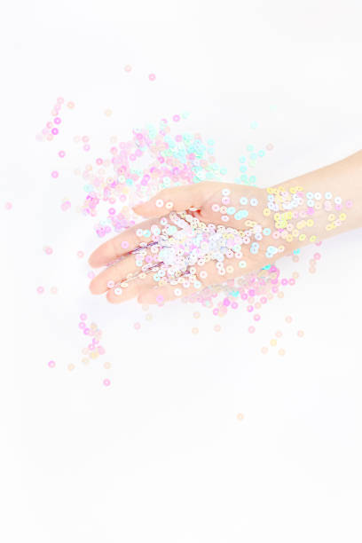 istock Pearl pastel confetti sparkles with woman hand 1194708838