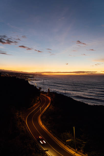 Flight above ocean waves facing beautiful sunset and mountains on horizon. Beautiful sunset on Tenerife, Canary Islands, Spain
