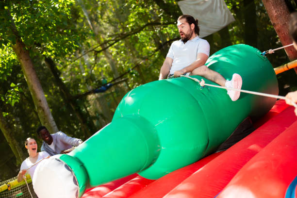 istock Smiling guy saddling inflatable rodeo bottle 1194712439