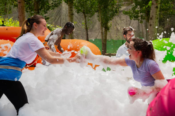 istock Adults collecting balls in inflatable pool with foam 1194712475