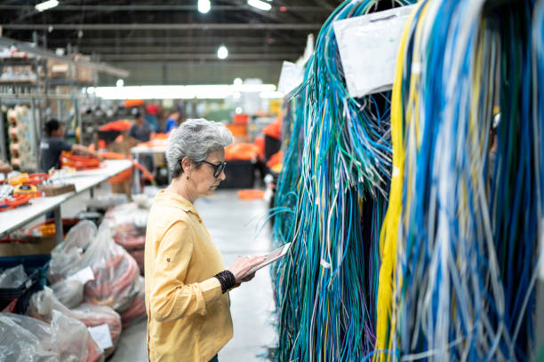 istock Businesswoman using digital tablet and working in a factory 1194716782