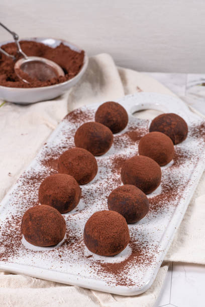 istock Fine chocolate truffles on white ceramic plate. 1194717068
