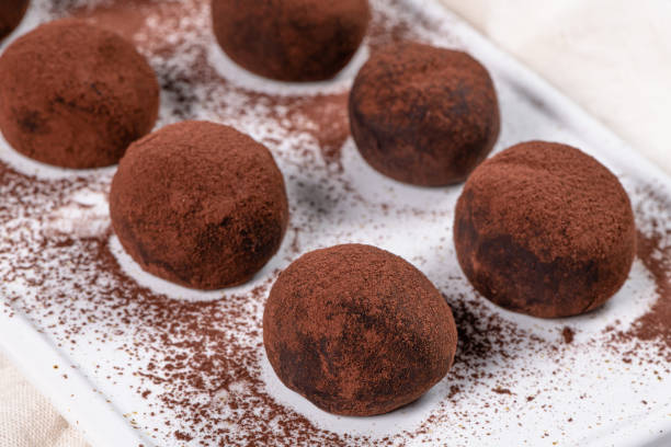 istock Fine chocolate truffles on white ceramic plate. 1194717087