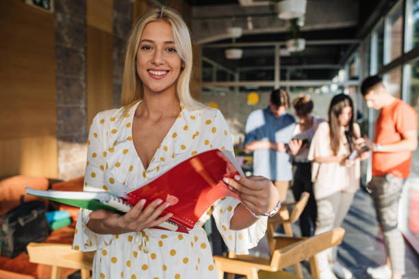 istock Beautiful young student with textbooks 1194720783