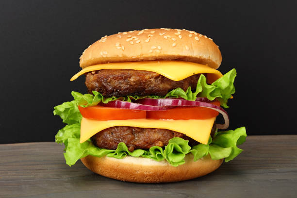istock bbq hamburger with vegetables, spices on dark wooden background 1194722093