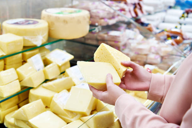 istock Hands with cheese in shop 1194725428