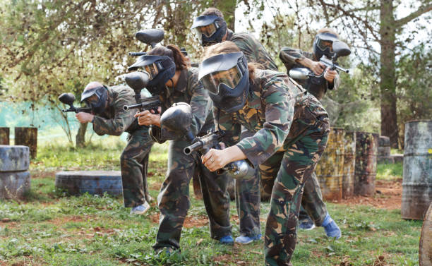 istock Paintball team running with marker guns 1194727985