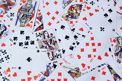 The concept of gambling. Scattered deck of cards on the table. Background. Close up.
