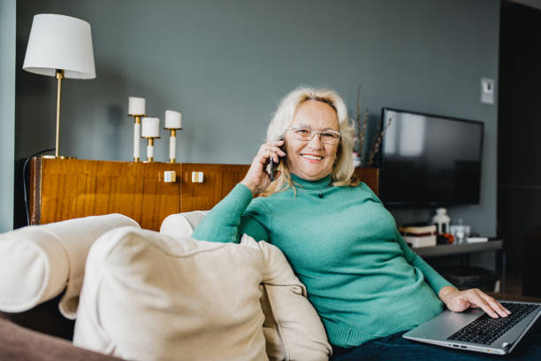 istock Senior woman using laptop at home 1194729483