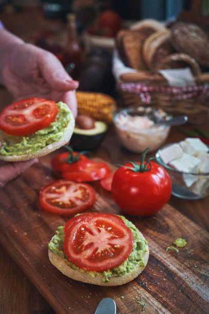 Preparing Avocado Sandwich with Tomato and Feta Cheese