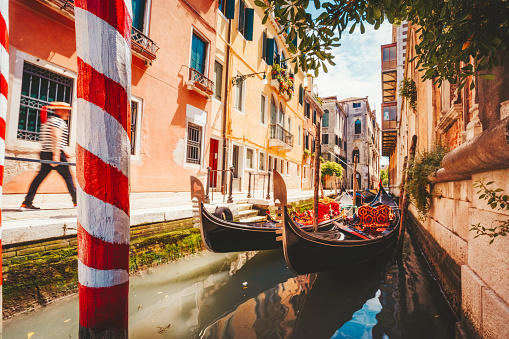 Gondolas boat floating in narrow canal of Venice city on beautiful sunny day. Italy. Europe